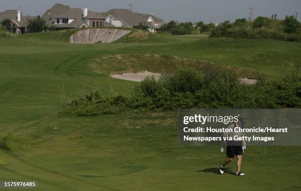 Eddie Busch walks through hole called 'Sam's Solution' in the Scotland links-style golf courses, a course with little or no trees, plenty of tall...