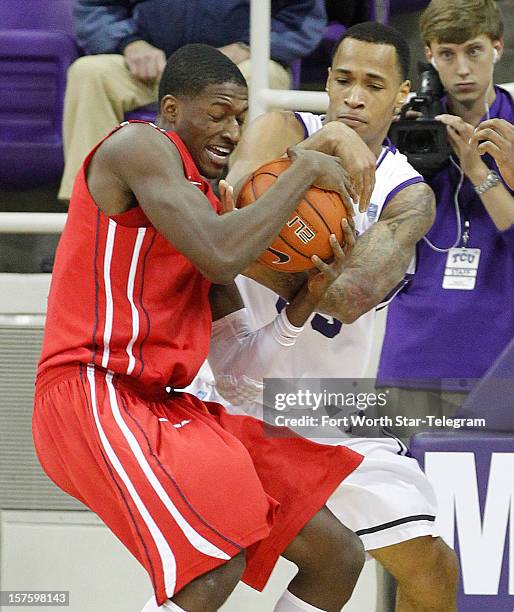 Texas Christian's Garlon Green, right, tries to strip the ball from Houston's Mikhail McLean at Daniel-Meyer Coliseum in Fort Worth, Texas on...