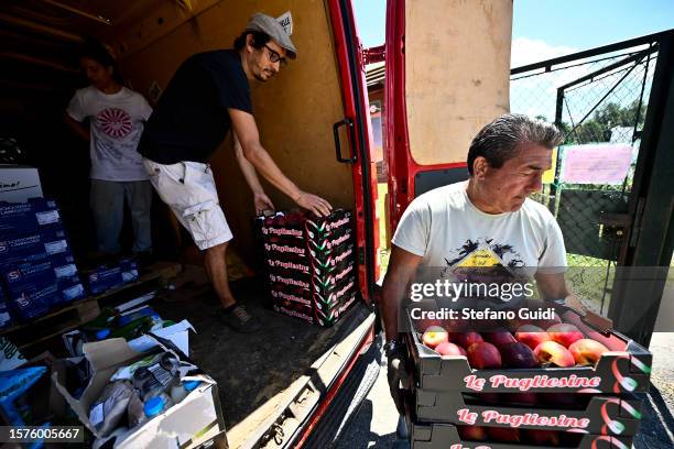 Giuseppe Deplano, an Italian earthworm farmer, and Luigi, a collaborator, transport fruit waste at an earthworm farm on July 27, 2023 in Turin,...