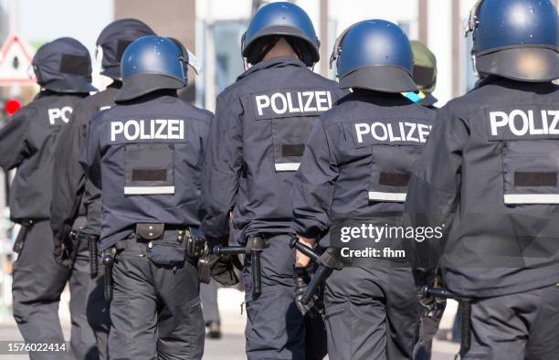 group of german policemen in action - police uniform stockfoto's en -beelden