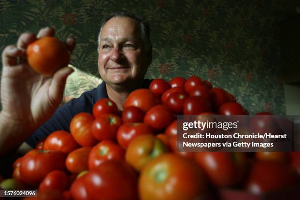 Douglas McLeod, Master Gardener, sits in front of approximately 300 tomatoes in his kitchen on Tuesday, June 10, 2008 in Houston, TX. He planted 60...