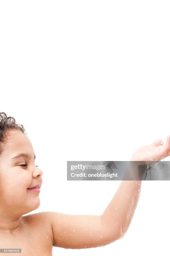 Child getting showered against white background