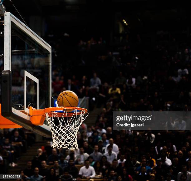 basketball net with basketball near hoop - basketball stadium stockfoto's en -beelden