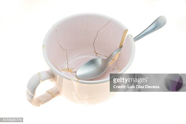 teaspoon  inside broken cup - crack spoon stock pictures, royalty-free photos & images
