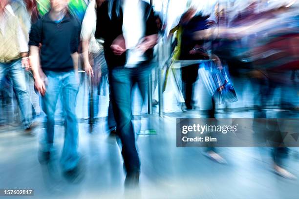 crowd of people walking through entrance gate, blurred motion - man walking feet inside stock pictures, royalty-free photos & images