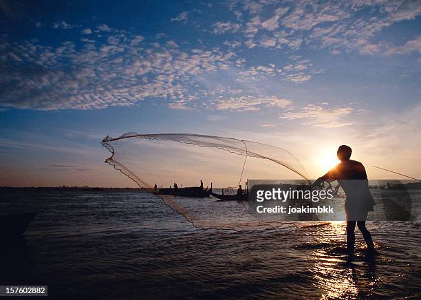 net fisherman on the mekong river in cambodia - river mekong stock pictures, royalty-free photos & images