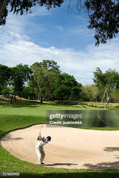 a golf player hitting the ball from the sand - hua hin thailand stockfoto's en -beelden