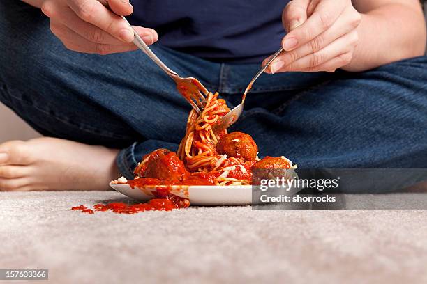 slob eat spaghetti and meatballs sitting on a carpeted floor - damaged carpet stock pictures, royalty-free photos & images