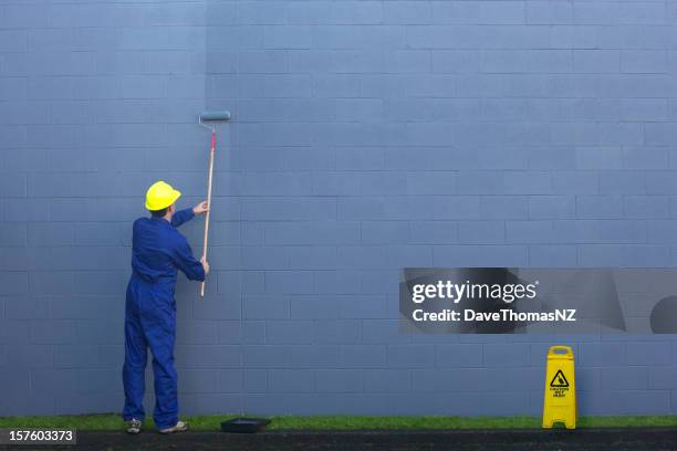 painting a wall outside. - sports helmet stock pictures, royalty-free photos & images