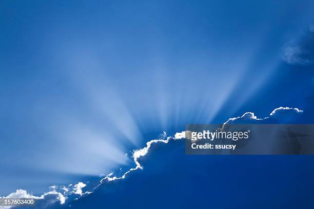 sun rays peeking out from behind clouds, exemplifying hope - every cloud has a silver lining stock pictures, royalty-free photos & images