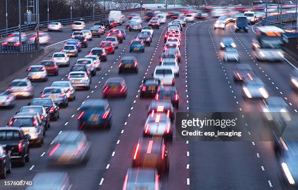 busy urban motorway at dusk - traffic stock pictures, royalty-free photos & images