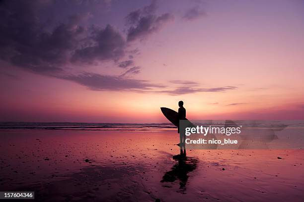 surfer at sunset - costa rica beach stock pictures, royalty-free photos & images