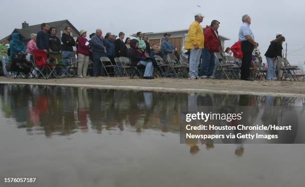 High tide reaches the congregation of Seaside Baptist Church attending an Easter Sunrise service on the beach on April 12, 2009 in Jamaica Beach, TX....