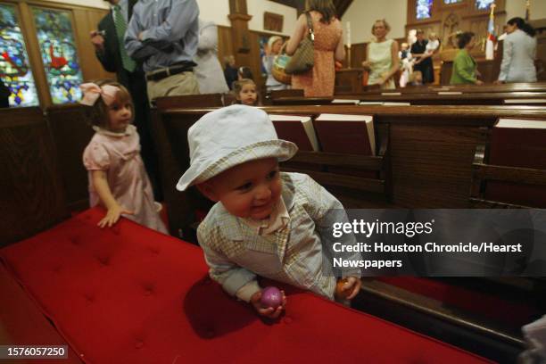 Claire Lane and Carson Crockett find eggs during the Easter egg hunt inside the chapel after attending Easter Service at The Church of St. John the...