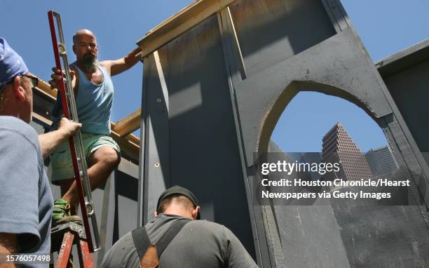 Kevin Westwood, Mitchell Clemons and Karl Graf connect walls for the 20-foot tall replica of the Blarney Castle, an Irish landmark built nearly 600...