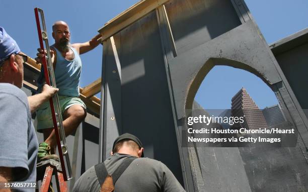Left to right) Kevin Westwood, Mitchell Clemons and Karl Graf, connect walls for the 20-foot tall replica of the Blarney Castle, an Irish landmark...