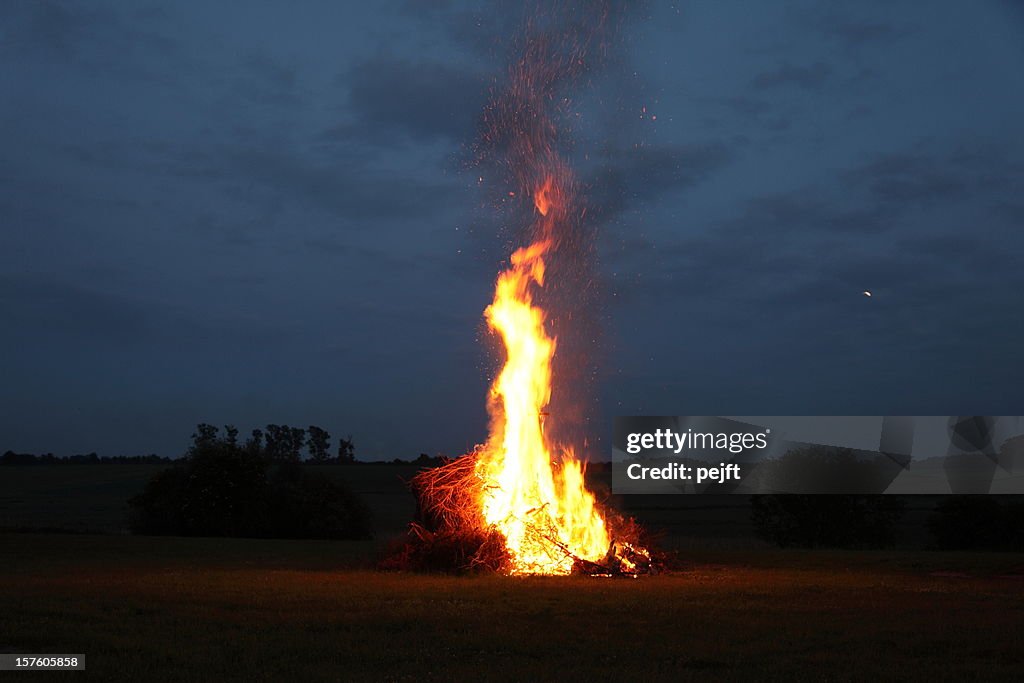 Bonfire at midsummer with moon in the sky