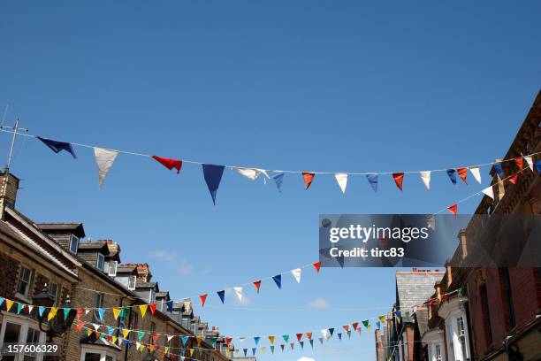 bunting flags against blue sky - bunting stock pictures, royalty-free photos & images