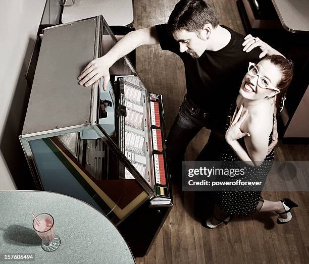 retro 50's couple at the jukebox - soda fountain stock pictures, royalty-free photos & images