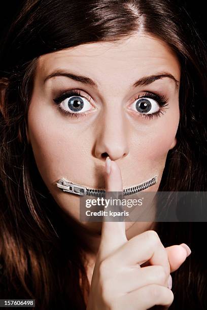 silenced - woman with finger on lips stock pictures, royalty-free photos & images