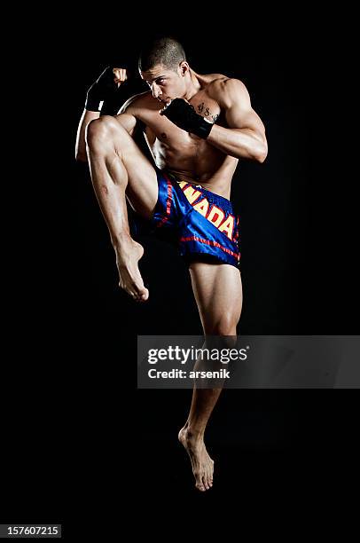 jumping knee kick - muaythai boxing stock pictures, royalty-free photos & images