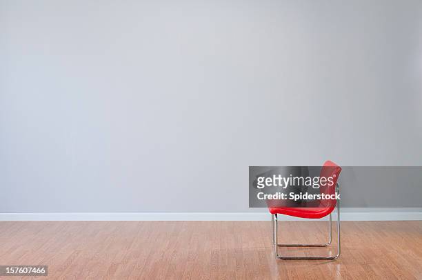 retro red chair in empty room - wainscoting stock pictures, royalty-free photos & images