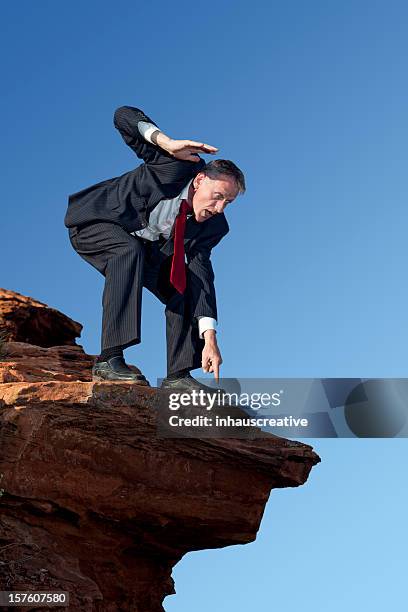 businessman looking over the edge - bending over stock pictures, royalty-free photos & images