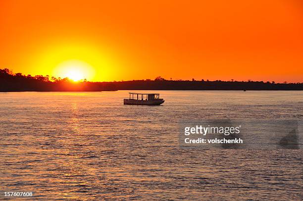sunset on zambezi - zambezi river stock pictures, royalty-free photos & images