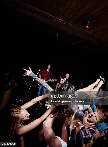 crowd surfing at a rock concert - crowd surfing stock pictures, royalty-free photos & images