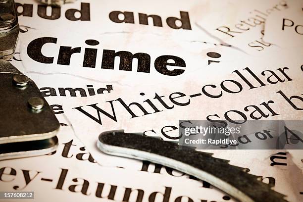 close up of headlines on financial crime with handcuffs - ponzi scheme stock pictures, royalty-free photos & images