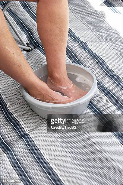man soaking feet in bowl of hot water - wash bowl stock pictures, royalty-free photos & images