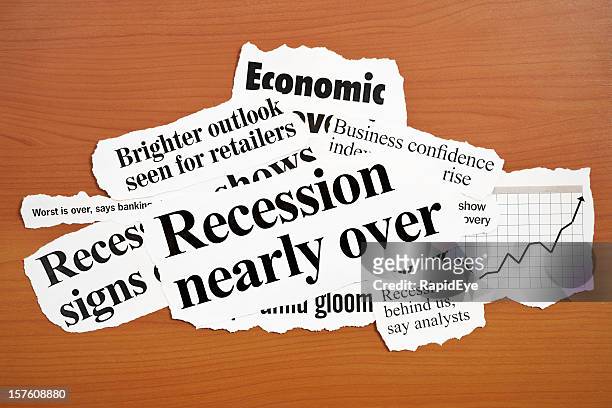 headlines announcing economic recovery on wooden desk - newspaper clippings stock pictures, royalty-free photos & images