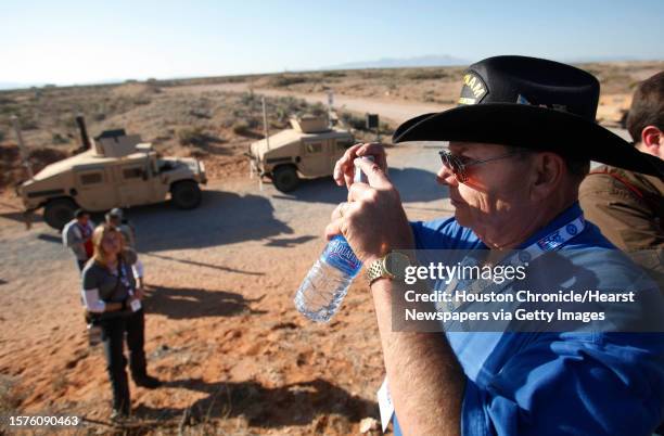 Mike Pyykola, representative of the Veteran of Foreign War Post 8790, photographs humvees at Camp McGregor where employers and community...