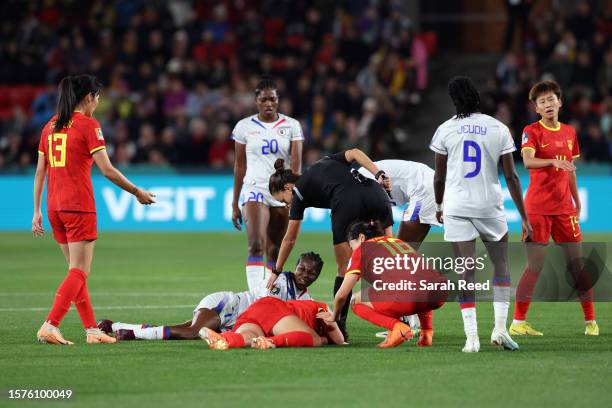 Batcheba Louis of Haiti and Zhang Rui of China PR lie on the pitch after their collision during the FIFA Women's World Cup Australia & New Zealand...