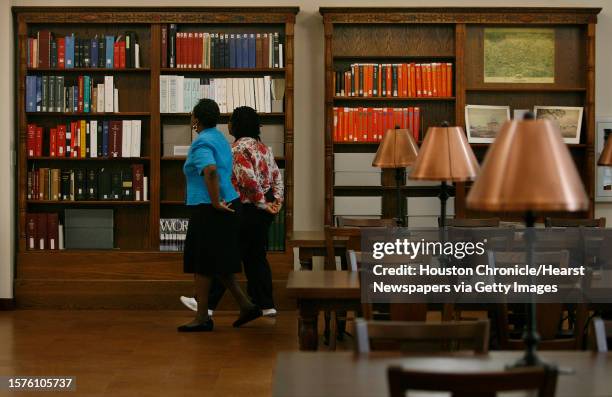 Caroline Collins and Lisa Norment look through books at Houston's Library Julia Ideson Building which is partly reopened after it's facelift which...