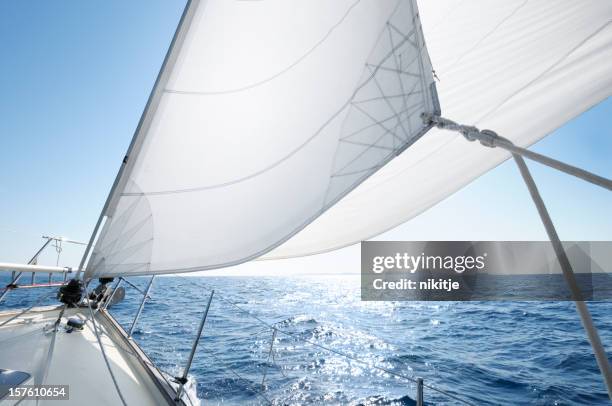 boat under sail on a sunny day - yachting stockfoto's en -beelden