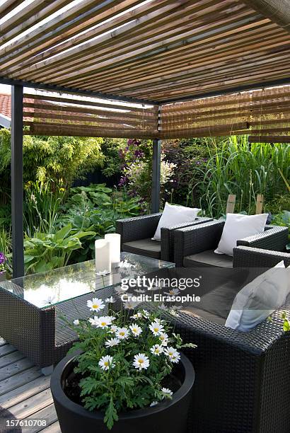 modern garden with a pergola and wicker sofa - patio furniture stock pictures, royalty-free photos & images