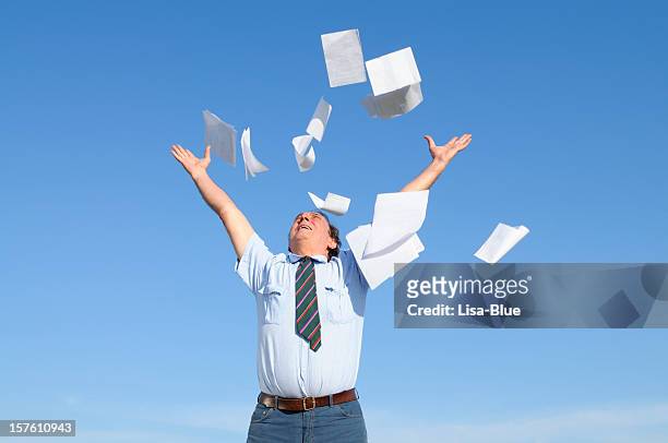 businessman throwing papers blue sky - paper flying stock pictures, royalty-free photos & images