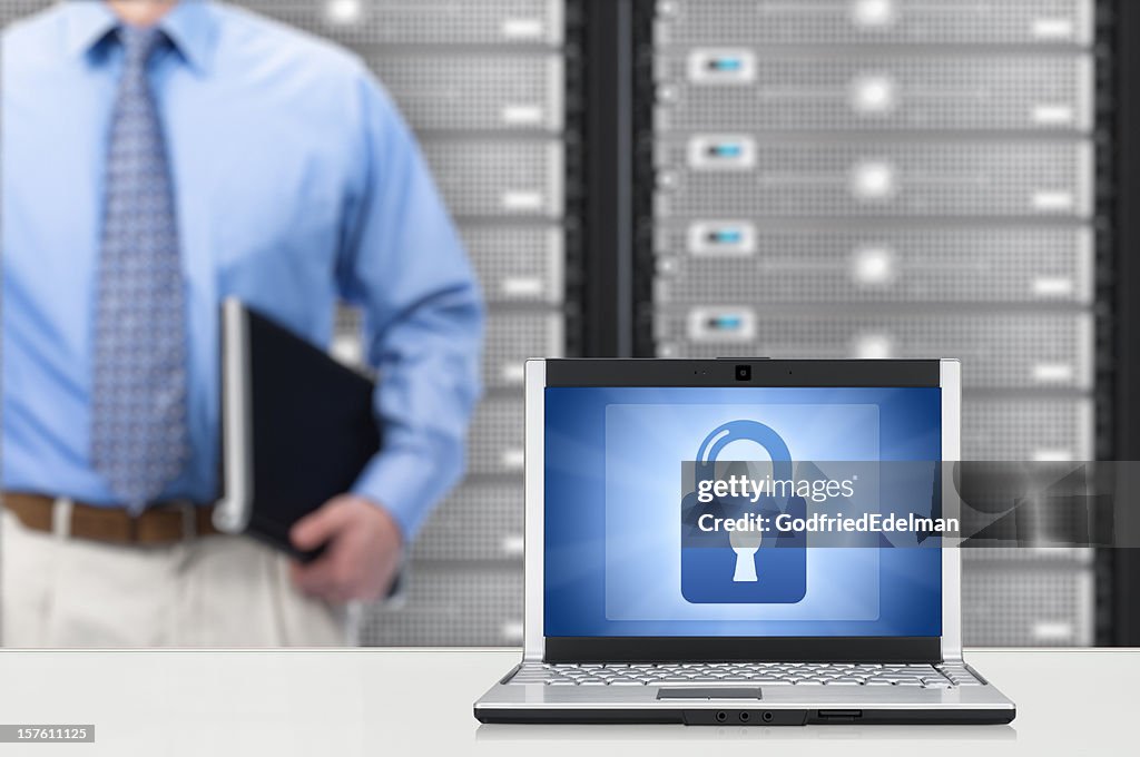 Man standing close to a laptop showing a lock sign