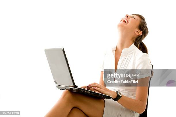 young woman laughing working on laptop - fabio filzi stock pictures, royalty-free photos & images