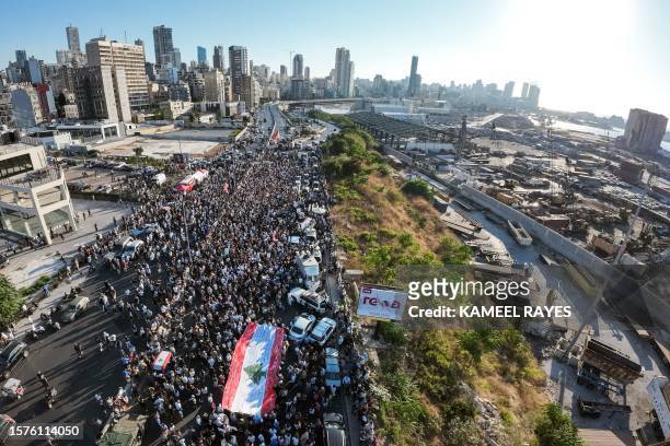 This aerial view shows demonstrators marching outside the port of Beirut on August 4 to mark the third anniversary of the deadly harbour explosion...
