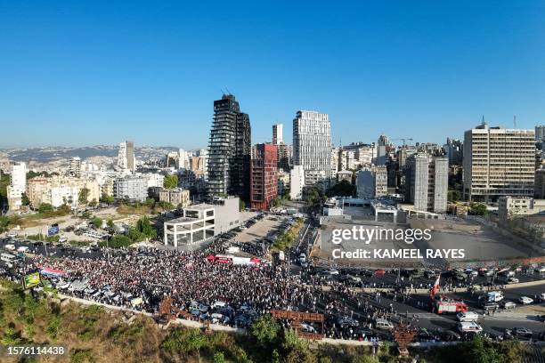 This aerial view shows demonstrators marching outside the port of Beirut on August 4 to mark the third anniversary of the deadly harbour explosion...