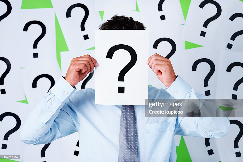 Business executive holding a sheet with question mark