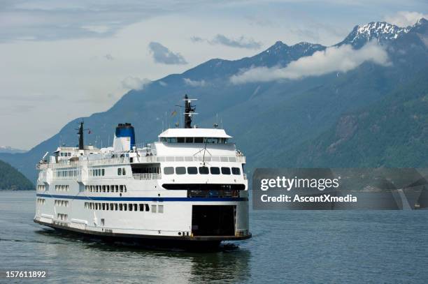 a ferry sailing through a waterway surrounded by hills - nanaimo stock pictures, royalty-free photos & images