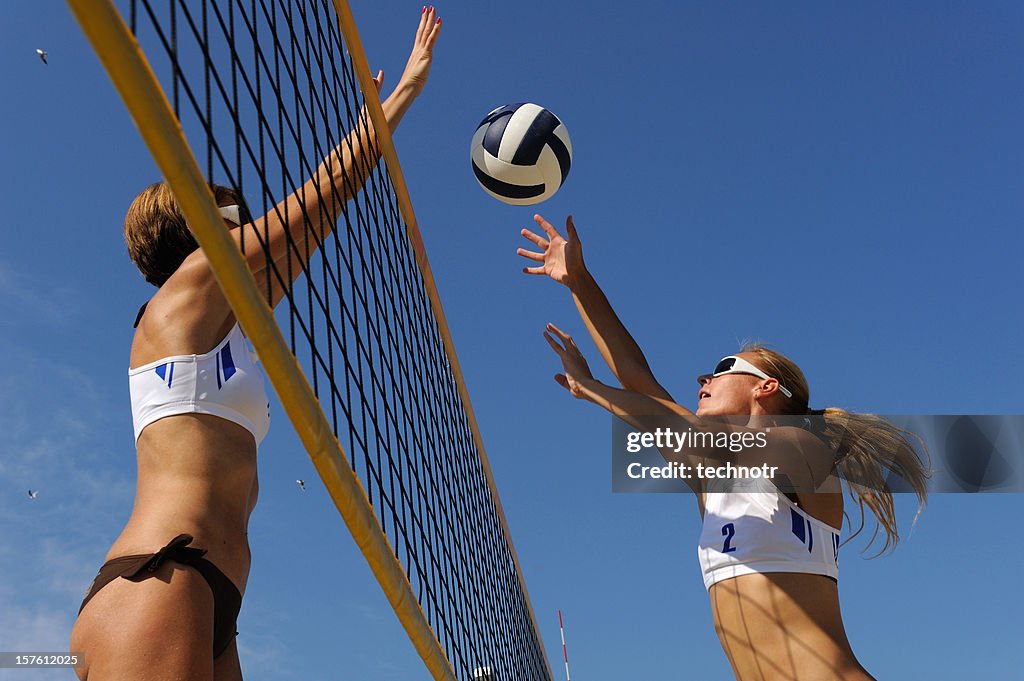 Beach volley action in mid-air