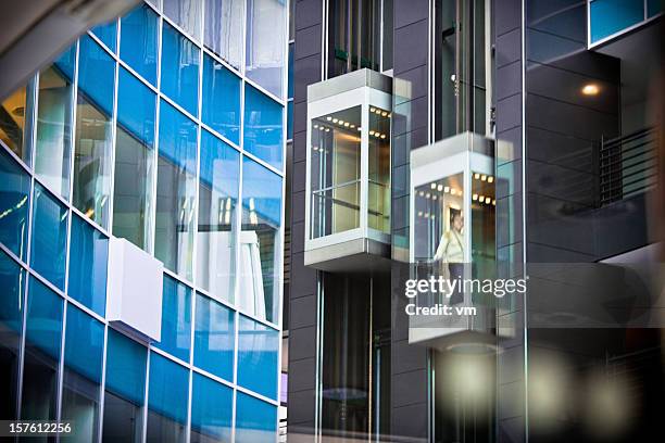 elevators inside modern office building - building atrium bildbanksfoton och bilder
