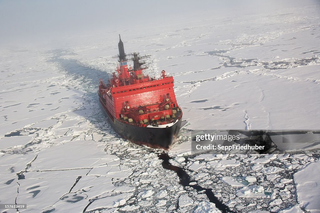 A red nuclear ice breaker ship in iceberg water