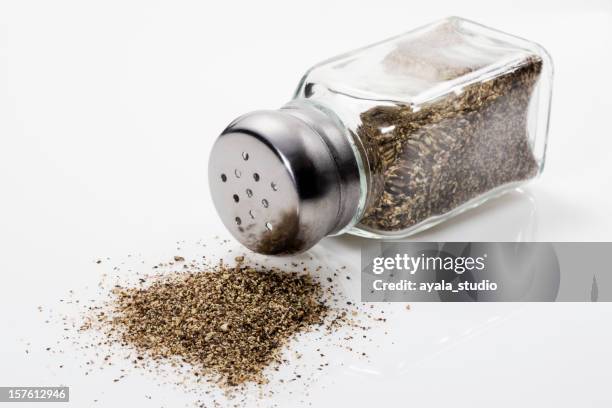 spilled pepper shaker, close up - salt and pepper shakers stock pictures, royalty-free photos & images