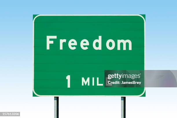 freedom, one mile; actual highway sign - mile stock pictures, royalty-free photos & images