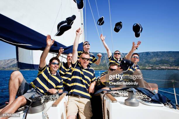 happy sailing crew on sailboat - boat captain stockfoto's en -beelden